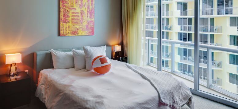 Beach ball on bed in hotel room